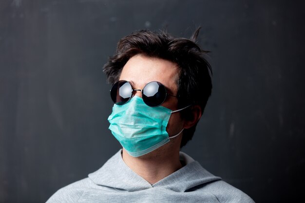 Young white man in protective mask and sunglasses