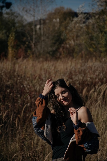 Young, wind and free girl in boho clothes walks in the forest.