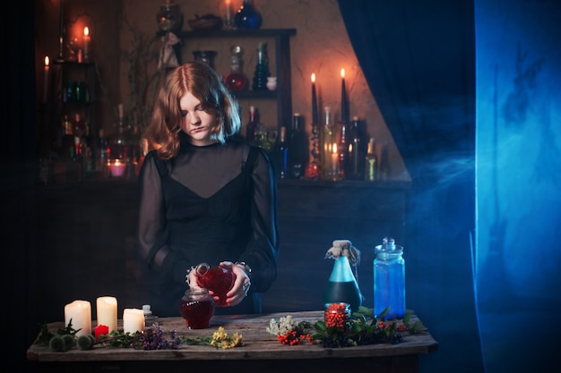 Photo young witch in home. halloween concept