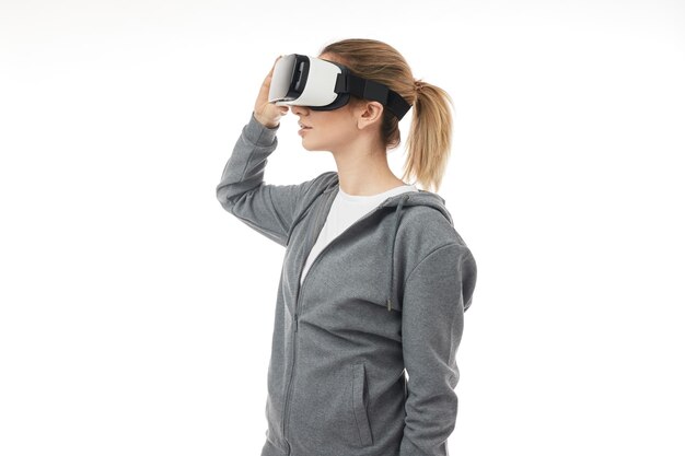 Young woman adjusting glasses of virtual reality