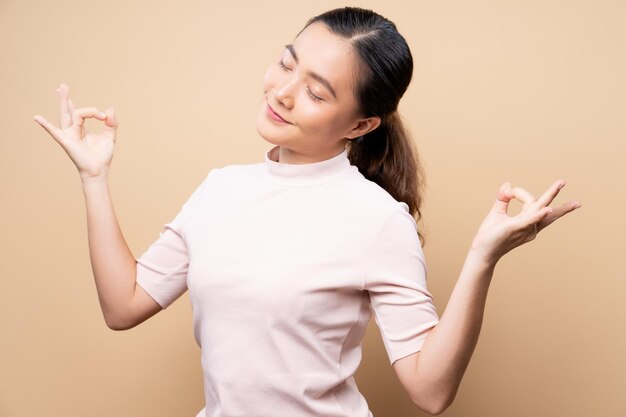 Young woman against beige background