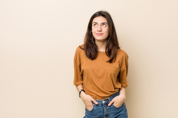 Young woman against a beige background 