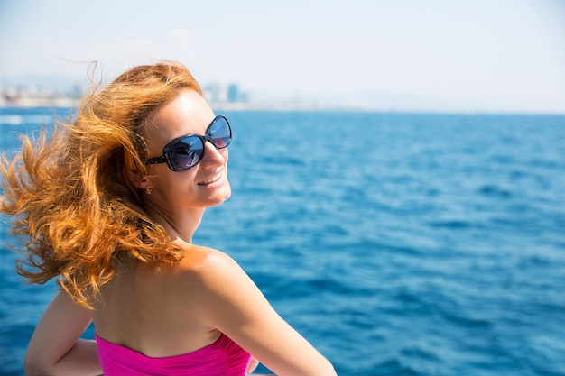 Young woman against sea