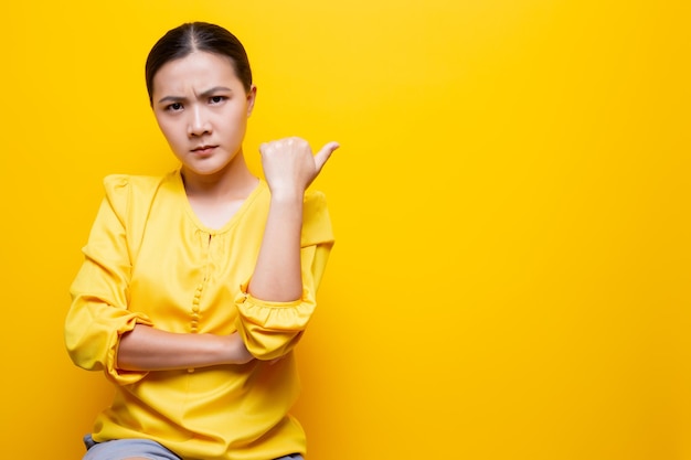 Young woman against yellow background