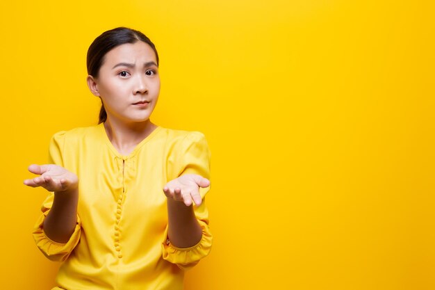 Young woman against yellow background