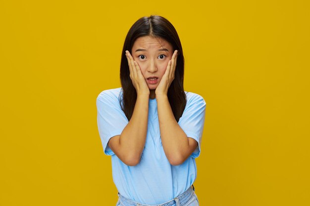 Young woman against yellow background