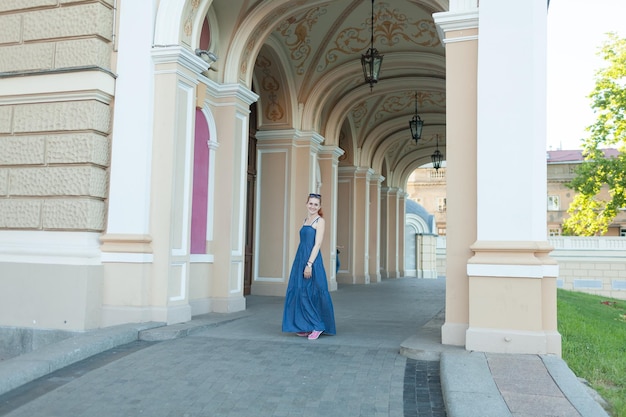 young woman in the aisle of the arches of the building. beautiful architecture