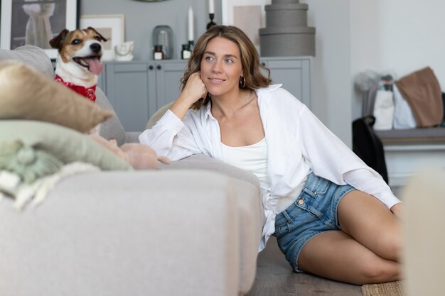 写真 若い女性と自宅のソファで彼女の犬。愛らしいペット。