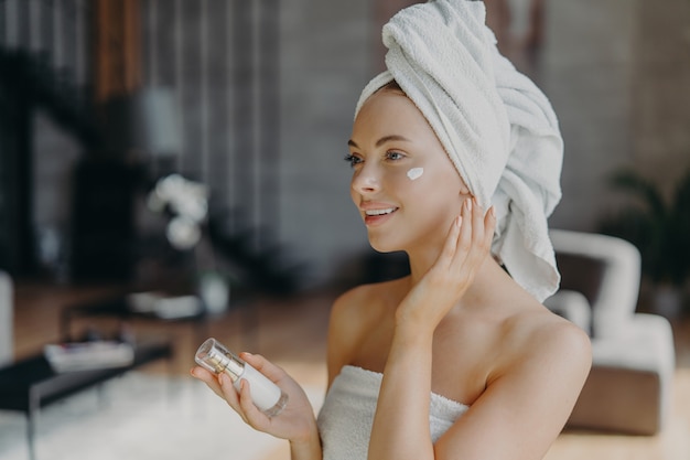 Young woman applying the cream for a spa treatment