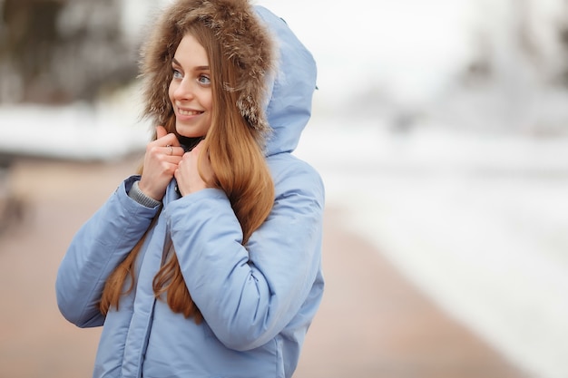 Young woman are walking in the winter park