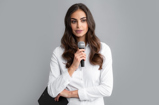 Young woman as reporter with microphone and clipboard Female journalist with microphone and clipboard