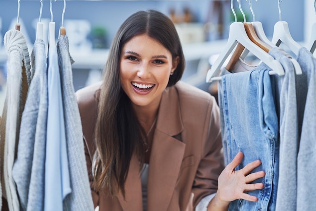 Young woman as a store manager with clothes. High quality photo