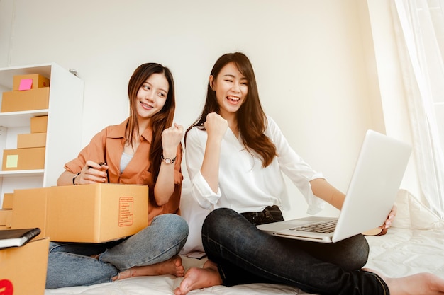 Young woman asian work from home talking with customers to sell products online and delivery