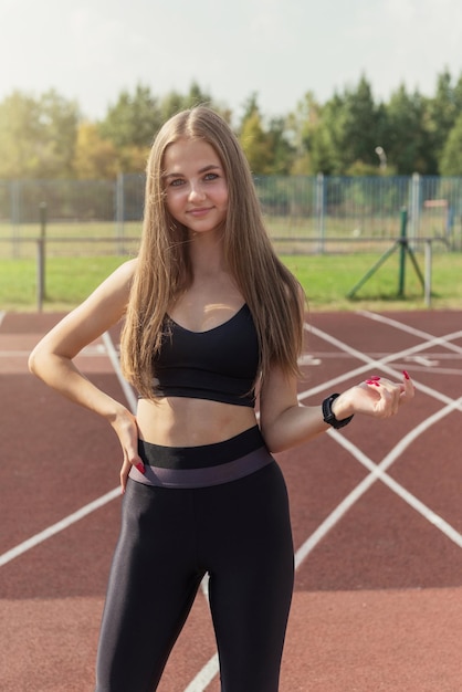 Corridore dell'atleta della giovane donna allo stadio all'aperto