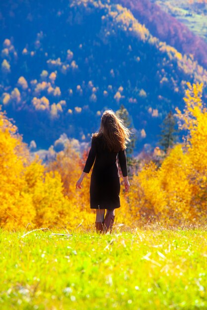 Young woman in the autumn forest