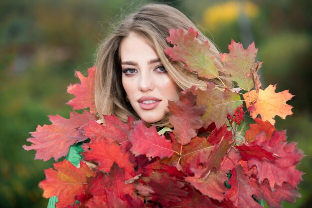 Young woman in autumn park warm sunny weather fall concept hello autumn happy woman with autumn yell