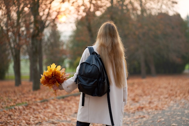 Young woman in the autumn park