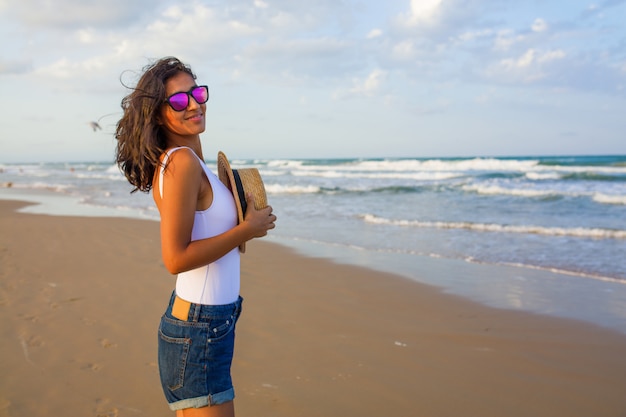 Young woman back to back on the beach