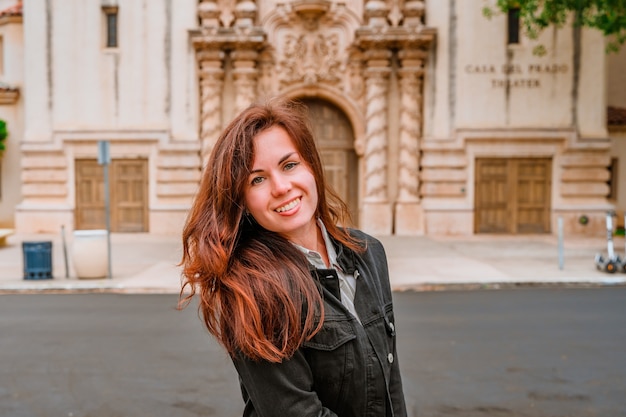 a young woman in the background of the theater with beautiful architecture in balboa