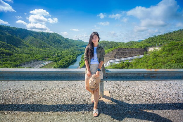 Young woman backpacking traveling front view