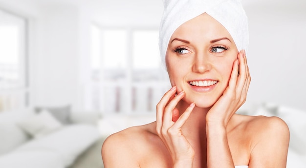 Young woman in bath towel with perfect clean skin