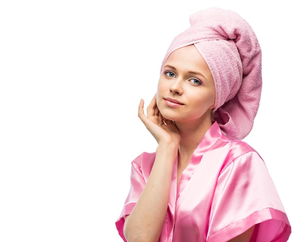 Young woman in bathrobe and towel on head