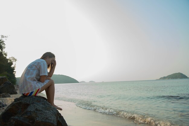 Young woman on the beach and be sad concept