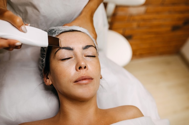 Young woman at a beauty salon having a face massage