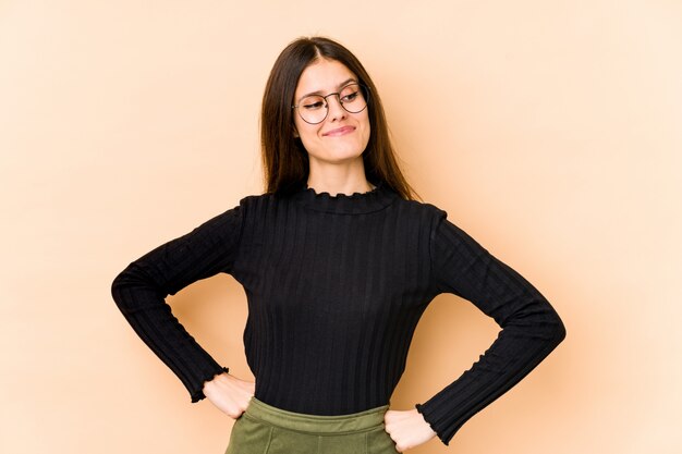 Young woman on beige dreaming of achieving goals and purposes