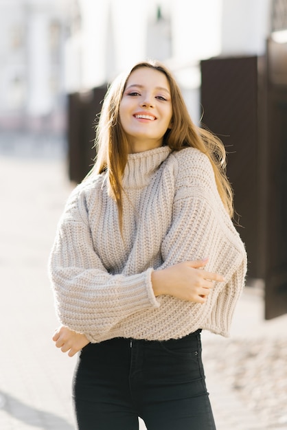 Young woman in a beige knitted sweater