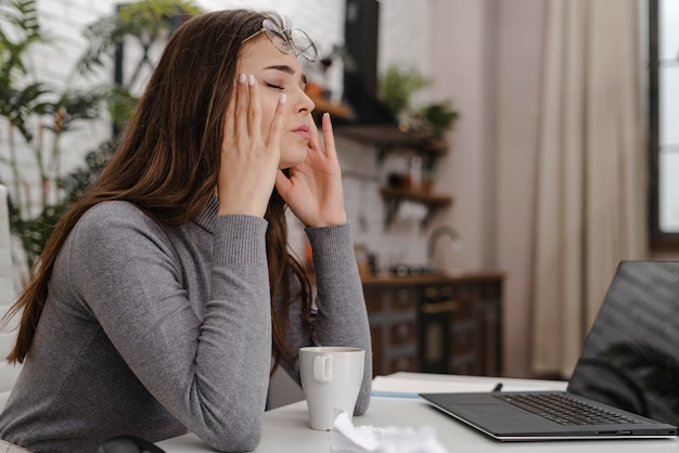 Young woman being sad while working from home