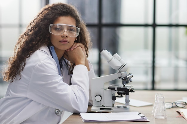 Young woman in biological laboratory Attractive young female scientis