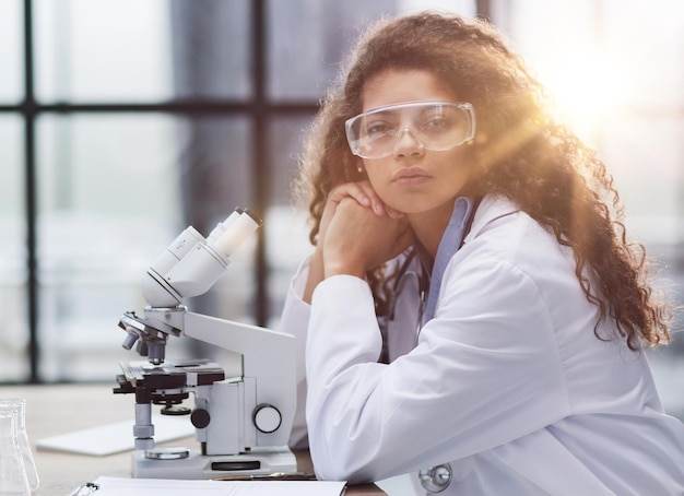 Young woman in biological laboratory Attractive young female scientis