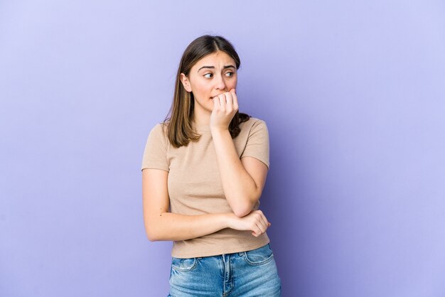 young woman biting fingernails, nervous and very anxious