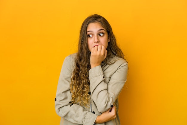 Young woman biting fingernails, nervous and very anxious