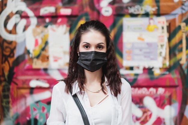 Young woman in a black mask. Protection against сovid-19. High quality photo