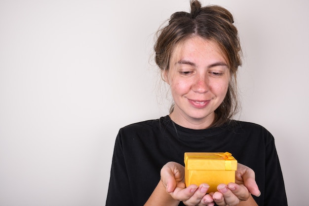 young woman in a black t-shirt is happy to accepting gift. accept gifts concept