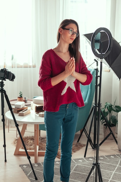 Young woman blogger getting ready to shoot video for vlog, backs