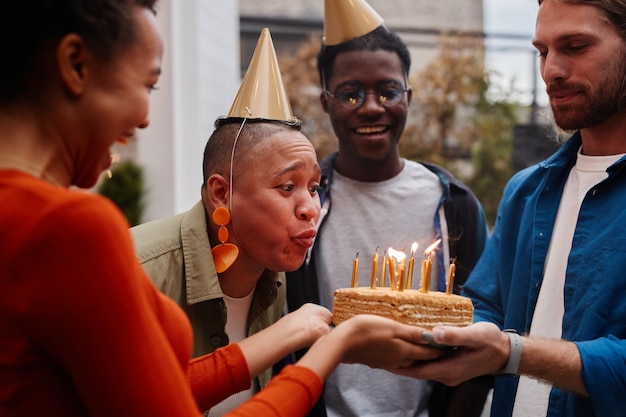 Young Woman Blowing Candles