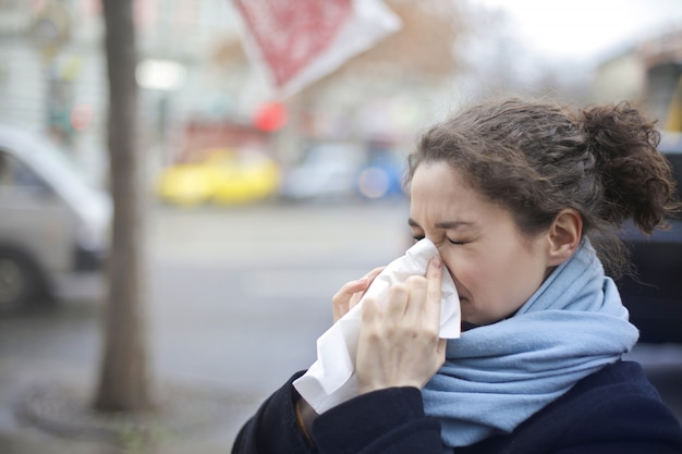 Young woman blowing her nose