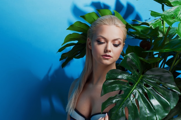 Young woman in blue bikini on blue.