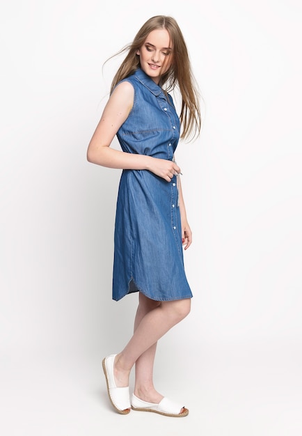 Young woman in a blue denim dress