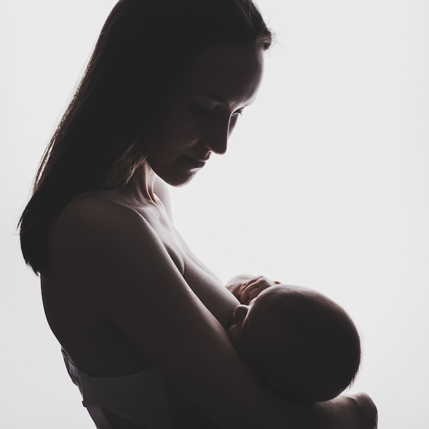 Young woman breastfeeding her newborn baby