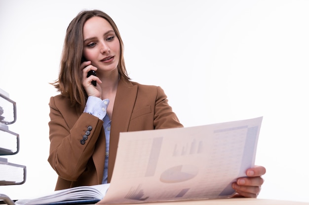 A young woman in a business suit working at a desk