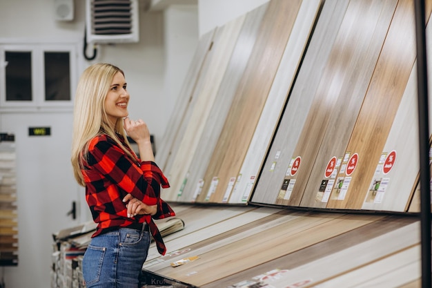 Young woman buying flooring in a hardware store