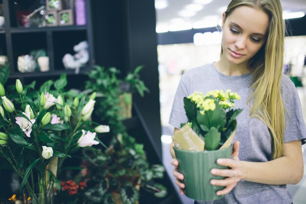 Young woman buying flowers at a garden center