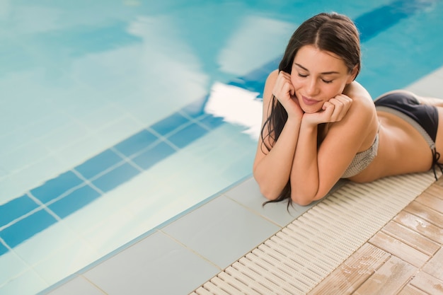 Young woman by the pool