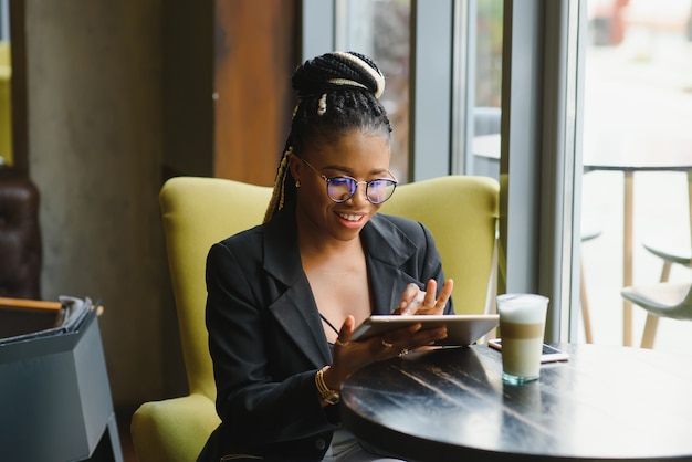 Young woman in a cafe using a tablet