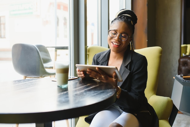 Young woman in a cafe using a tablet