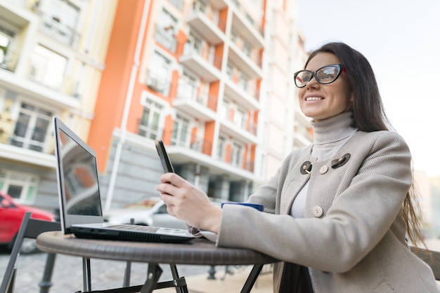 Young woman at the cafe with laptop